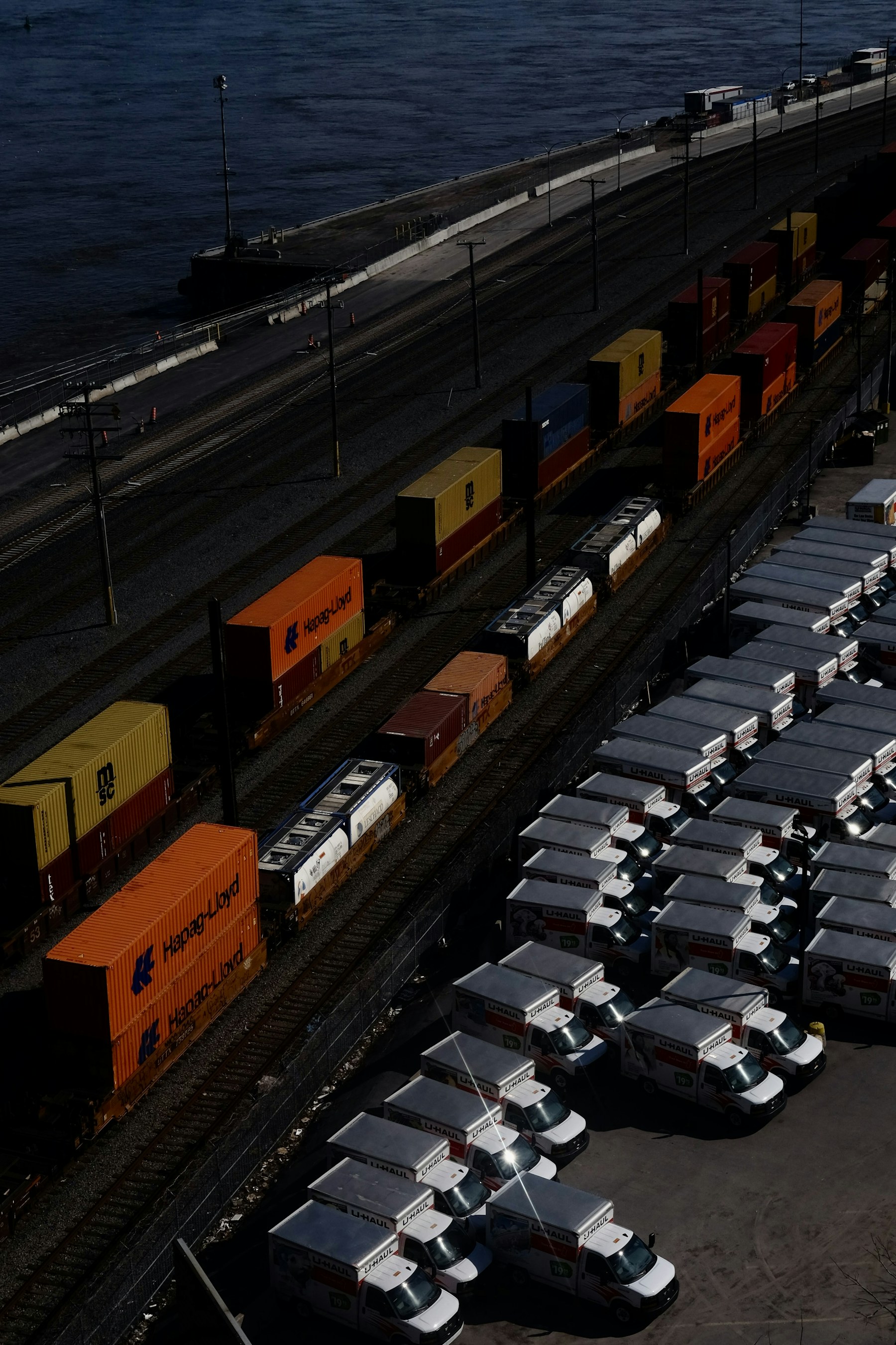 Aerial view of containers, trucks, and rail at a port